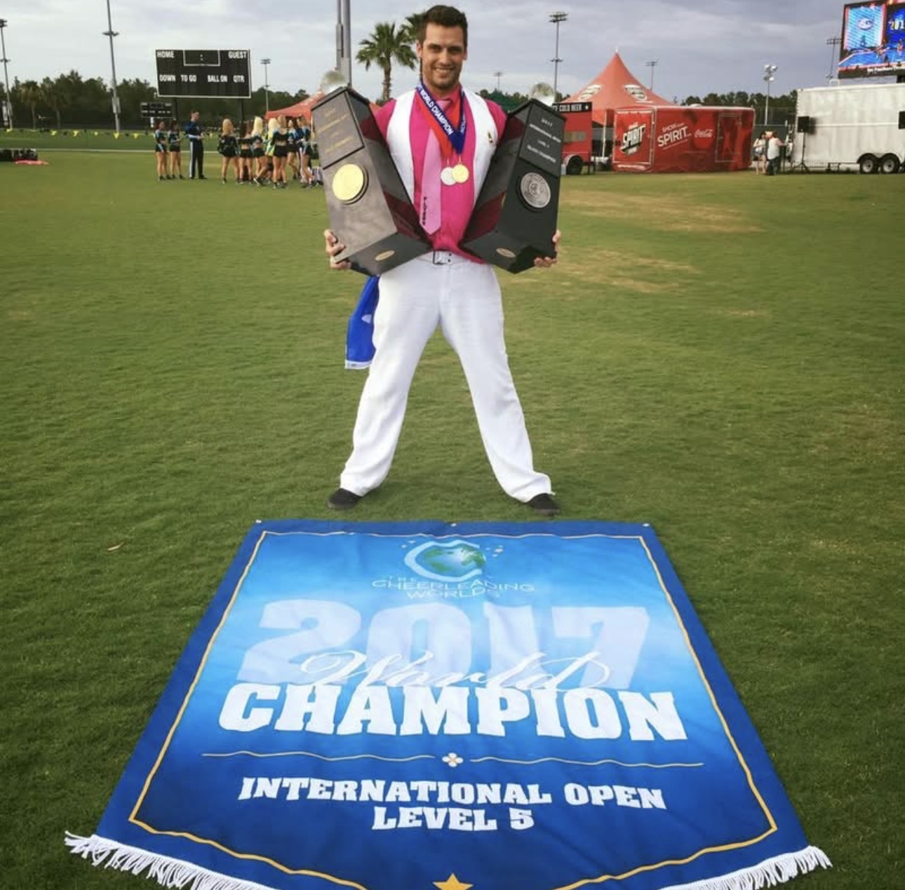 Charles holding two Worlds trophies